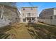 Spacious, fenced backyard showcasing a patio, second-story deck, and lawn at 4787 Dunkirk St, Denver, CO 80249