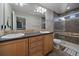 This bathroom features a double vanity, a glass shower, and tile accents at 4787 Dunkirk St, Denver, CO 80249