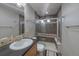 Well-lit bathroom features a glass-enclosed shower with brown tiling at 4787 Dunkirk St, Denver, CO 80249