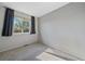 This simple bedroom offers neutral walls, carpeted floors, and natural light at 4787 Dunkirk St, Denver, CO 80249