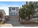 Charming three-story home with a brick and siding facade and a two-car garage at 4787 Dunkirk St, Denver, CO 80249