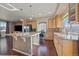 Spacious kitchen features a large island, stainless steel appliances, and hardwood floors at 4787 Dunkirk St, Denver, CO 80249