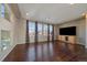 Bright and airy living room with hardwood floors, large windows, and a high ceiling at 4787 Dunkirk St, Denver, CO 80249