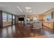 Spacious living room with hardwood floors, kitchen, and bright windows at 4787 Dunkirk St, Denver, CO 80249