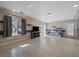 Cozy living room with modern light fixtures and ample sunlight streaming through the large window at 4787 Dunkirk St, Denver, CO 80249