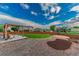 Landscaped backyard features a pergola, gravel paths, and a lush lawn, creating a serene outdoor space at 638 W 175Th Ave, Broomfield, CO 80023