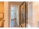 Bathroom with a glass enclosed shower that has stone-look tile work and an entry to a bedroom at 638 W 175Th Ave, Broomfield, CO 80023