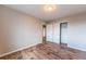 A cozy bedroom featuring wood-look flooring, neutral paint, and a closet with double doors at 638 W 175Th Ave, Broomfield, CO 80023