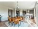 Sunlit dining area featuring a round wood table, modern chairs, stylish lighting, and easy access to the kitchen at 638 W 175Th Ave, Broomfield, CO 80023