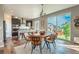 Bright dining area with a round table, modern chairs, large windows, and a view of the backyard at 638 W 175Th Ave, Broomfield, CO 80023