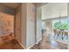 Hallway with a half bath, views into the dining area, and wood-look vinyl flooring at 638 W 175Th Ave, Broomfield, CO 80023