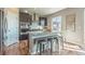 Modern kitchen with a gray island, barstool seating, stainless steel appliances, and a window view at 638 W 175Th Ave, Broomfield, CO 80023