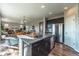 Open-concept kitchen featuring an island with seating, stainless steel appliances, and seamless access to the living area at 638 W 175Th Ave, Broomfield, CO 80023