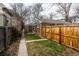 Charming backyard featuring a small lawn and a wooden fence for added privacy and security at 482 N Humboldt St, Denver, CO 80218