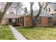 Charming brick home featuring a well-maintained lawn and mature trees at 482 N Humboldt St, Denver, CO 80218