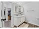 Bathroom with double sink vanity and a walk-in closet at 10950 W Florida Ave # 303, Lakewood, CO 80232