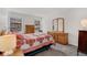 Cozy bedroom features two windows, a large dresser and a comfortable bed with a quilt at 10950 W Florida Ave # 303, Lakewood, CO 80232