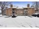Exterior of a brown condo building with balconies and snow-covered parking lot at 10950 W Florida Ave # 303, Lakewood, CO 80232