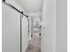 Bright hallway with sliding door and view to kitchen at 10950 W Florida Ave # 303, Lakewood, CO 80232