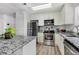 Modern kitchen with stainless steel appliances and gray granite countertops at 10950 W Florida Ave # 303, Lakewood, CO 80232