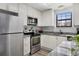 Bright kitchen features gray granite countertops and stainless steel appliances at 10950 W Florida Ave # 303, Lakewood, CO 80232