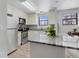 Bright kitchen features stainless steel appliances, white cabinets and an island with a granite countertop at 10950 W Florida Ave # 303, Lakewood, CO 80232