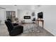 Cozy living room with fireplace, balcony access and gray floral rug at 10950 W Florida Ave # 303, Lakewood, CO 80232