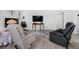 Living room has a gray floral area rug and furniture on the carpeted floor at 10950 W Florida Ave # 303, Lakewood, CO 80232