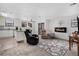 Bright living room features a fireplace, ceiling fan, and access to balcony at 10950 W Florida Ave # 303, Lakewood, CO 80232