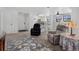 Living room and kitchen with white cabinets and bar seating at 10950 W Florida Ave # 303, Lakewood, CO 80232