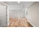 Light and bright, finished basement area with a door leading to another room and plenty of sunlight at 1996 W 66Th Ave, Denver, CO 80221