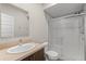 This bathroom features a neutral vanity, modern sink, glass enclosed shower and a white tiled shower at 1996 W 66Th Ave, Denver, CO 80221