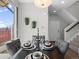 Elegant dining room with stylish furnishings, decorative hanging plants and a staircase to the second floor at 1996 W 66Th Ave, Denver, CO 80221