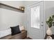Inviting entryway features a storage bench with coat hooks, and a door with decorative glass for natural light at 1996 W 66Th Ave, Denver, CO 80221