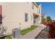 Exterior featuring a sliding glass door and a small grass area at 1996 W 66Th Ave, Denver, CO 80221