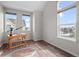 This office features a light wood desk, natural light from three windows, and hardwood floors at 1996 W 66Th Ave, Denver, CO 80221