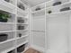 Spacious walk-in closet features custom built-in shelving and ample storage space for an organized wardrobe at 1996 W 66Th Ave, Denver, CO 80221