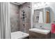 Modern bathroom featuring a shower with tiled walls, sleek fixtures, and a stylish vanity with ample counter space at 3100 Huron St # 4Q, Denver, CO 80202