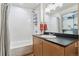 Bright bathroom featuring a bathtub, shower, and vanity with sleek fixtures and ample storage space at 3100 Huron St # 4Q, Denver, CO 80202