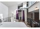 Comfortable loft bedroom featuring high ceilings, a large closet, a cozy chair, and natural light throughout at 3100 Huron St # 4Q, Denver, CO 80202