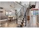 Dining room with modern chandelier, hardwood floors, and adjacent staircase at 3100 Huron St # 4Q, Denver, CO 80202