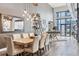 Bright dining room with modern chandelier, hardwood floors, and neutral color palette at 3100 Huron St # 4Q, Denver, CO 80202