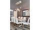 Stylish dining room with modern chandelier, hardwood floors, and bar at 3100 Huron St # 4Q, Denver, CO 80202
