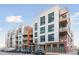 Modern apartment building featuring stylish architecture, multiple balconies, and convenient street parking at 3100 Huron St # 4Q, Denver, CO 80202