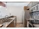 Kitchen featuring stainless steel appliances, stylish backsplash, and concrete countertops at 3100 Huron St # 4Q, Denver, CO 80202