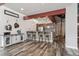 Open kitchen featuring bar-style seating, pendant lighting, and unique flooring at 3100 Huron St # 4Q, Denver, CO 80202