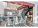Modern kitchen with bar seating, stainless steel appliances, and decorative backsplash at 3100 Huron St # 4Q, Denver, CO 80202