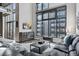 Modern living room boasts large windows, a comfortable sofa, and industrial chic decor at 3100 Huron St # 4Q, Denver, CO 80202