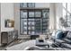 Bright living room with a large grid-patterned window and modern decor at 3100 Huron St # 4Q, Denver, CO 80202