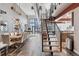 Bright living space featuring open floor plan, hardwood floors, and modern staircase at 3100 Huron St # 4Q, Denver, CO 80202